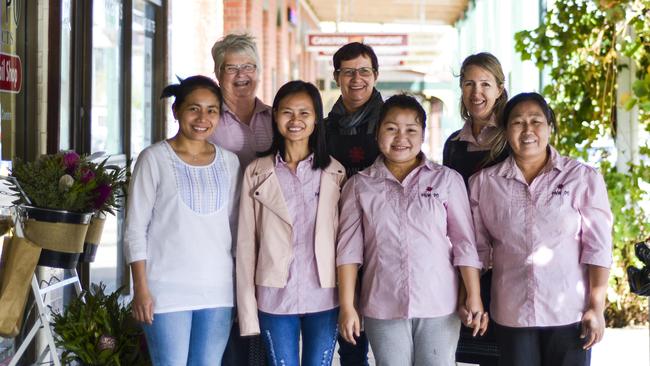 Sew keen: Nhill volunteers Phyliss Creek, Cathy Moll and Alison Creek with migrants Asoe Soe, Si Blu Htoo, April Noe and Ku MooThaei at the Paw Po store and learning centre at Nhill. Picture: Dannika Bonser