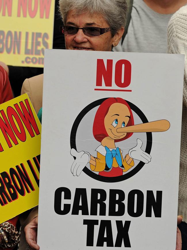 A protester holds a placard protesting plans for a carbon tax. Picture: AFP