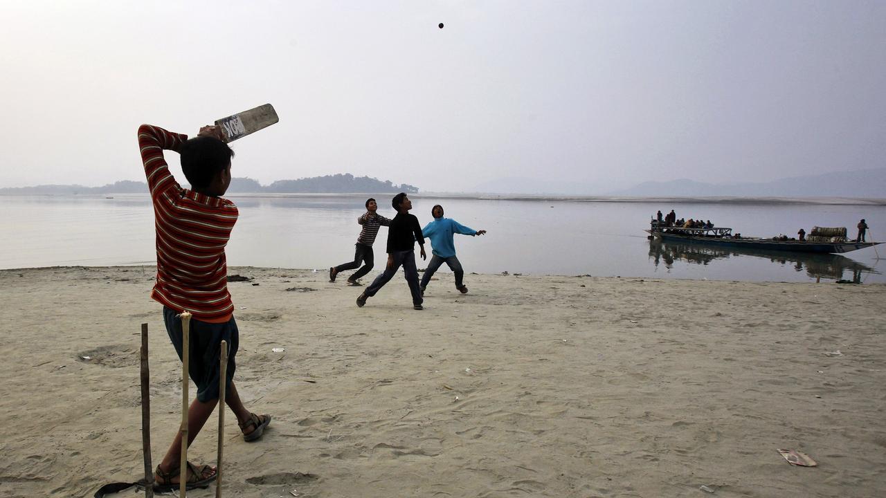 Children play cricket on the banks of the River Brahmaputra in India. The river’s source is in China, however.