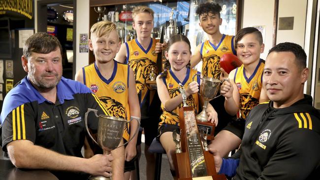 Salisbury West Football Club wants to return to the Adelaide Footy League after it was kicked out last year. New president Matthew Bates (left) and integrity officer Anthony Brennan (right) Callum, Caleb, Ella, Barialai and Lachlan. Picture: Dean Martin