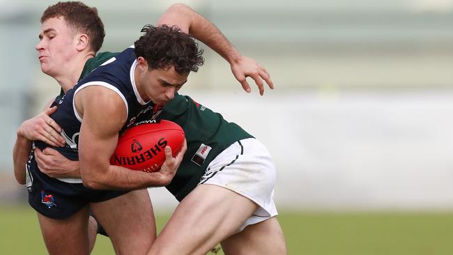 Ballarat’s Mitch Fino is tackled by Hampden’s Hamish Cook. Picture Yuri Kouzmin