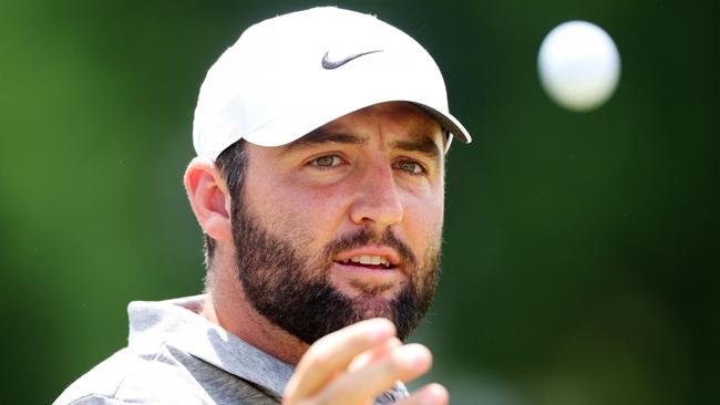 Scottie Scheffler of the United States tosses his ball on the driving range during the third round of the 2024 PGA Championship at Valhalla Golf Club.