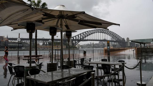 Tables and chairs are stacked away at a closed restaurant at Circular Quay in Sydney. New South Wales has recorded 50 new locally transmitted coronavirus cases reported on Saturday. Picture: NCA NewsWire/Bianca De Marchi