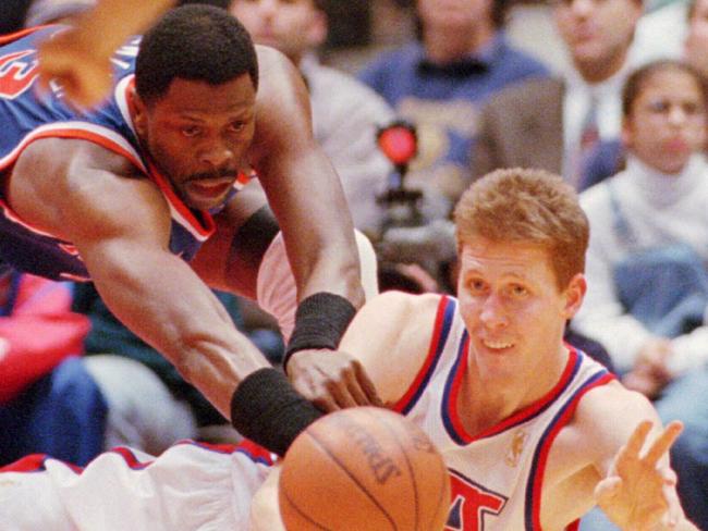 04DEC96- New York Knicks center Patrick Ewing, left, and New Jersey Nets center Shawn Bradley scramble on the floor after a loose ball during the first half, in East Rutherford, N.J.  (AP Photo/Bill Kostroun).a/ct/NBA/basketball