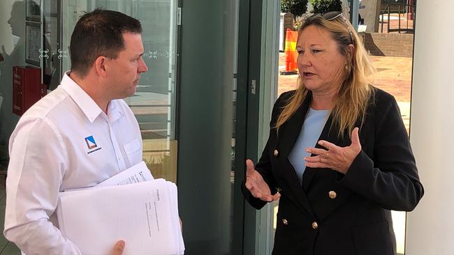 Mayor Matt Burnett receives a petition for a rates reduction and freeze from Jo-Ann Cuthbertson.