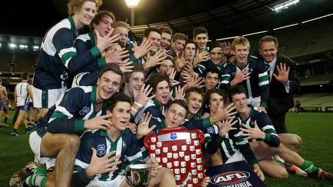 St Patrick's College celebrate their 5th straight Herald Sun Shield win in 2014. Howard Clark is on the right. Picture: Colleen Petch.