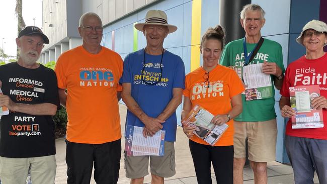 In Cairns at Westcourt DFO on the first day of pre-polling, party supporters defied the rain to hand out how-to-vote cards to people from 8am when the polls opened. Picture: Alison Paterson