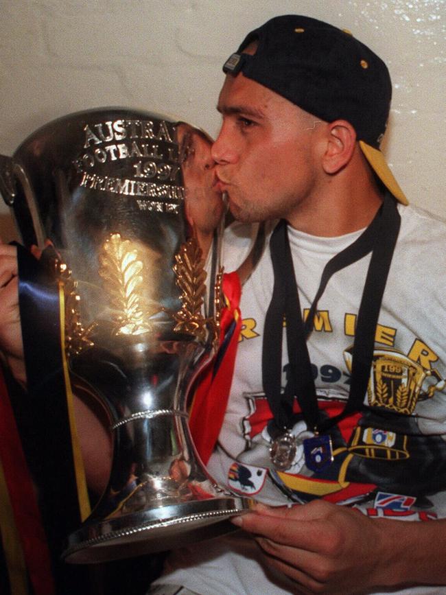 McLeod, wearing the Norm Smith Medal, and kissing premiership cup after the 1997 AFL Grand Final against St Kilda.