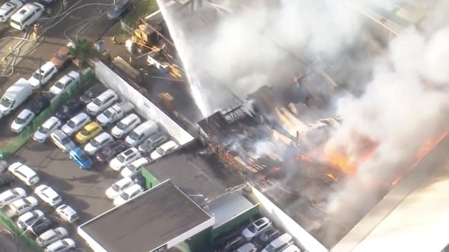 Two cranes are extinguishing the fire from above. Photo: Channel 7