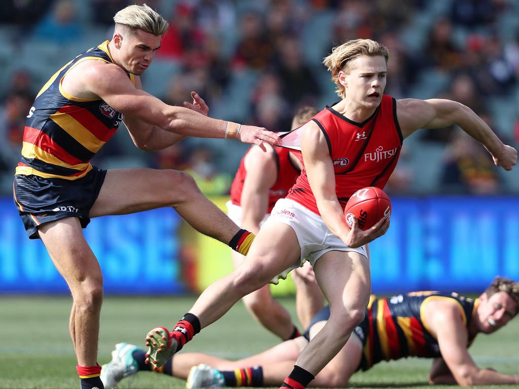 Essendon's Ned Cahill under pressure from Adelaide's Ben Keays Picture:Sarah Reed