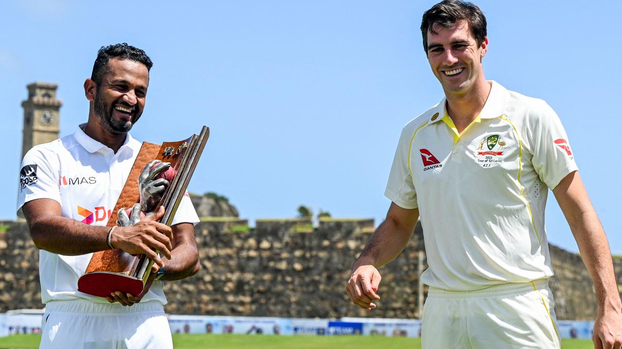 Sri Lanka’s captain Dimuth Karunaratne and Australia's captain Pat Cummins pose with Warne-Muralitharan Test trophy.