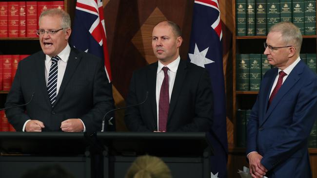 Prime Minister Scott Morrison, Treasurer Josh Frydenberg and Minister for Communications, Cyber Safety and the Arts Paul Fletcher during a press conference in Melbourne on Thursday.