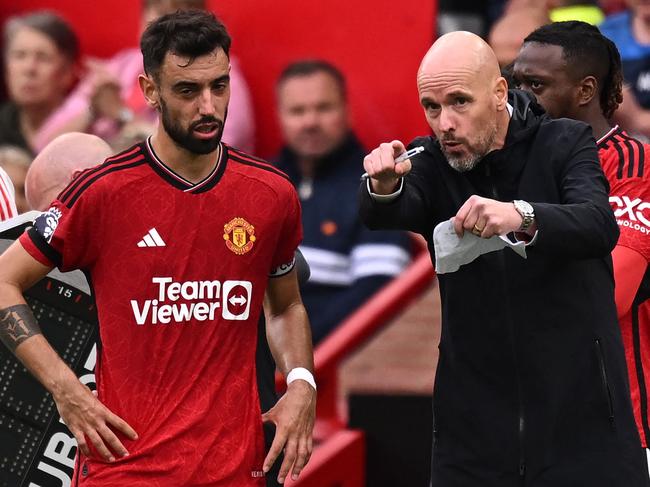 Manchester United's Dutch manager Erik ten Hag (R) gives instructions to Manchester United's Portuguese midfielder #08 Bruno Fernandes (L) during the English Premier League football match between Manchester United and Brighton and Hove Albion at Old Trafford in Manchester, north west England, on September 16, 2023. (Photo by Oli SCARFF / AFP) / RESTRICTED TO EDITORIAL USE. No use with unauthorized audio, video, data, fixture lists, club/league logos or 'live' services. Online in-match use limited to 120 images. An additional 40 images may be used in extra time. No video emulation. Social media in-match use limited to 120 images. An additional 40 images may be used in extra time. No use in betting publications, games or single club/league/player publications. /