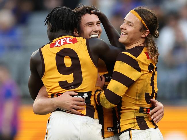 Connor Macdonald celebrates a goal with Changkuoth Jiath and Jack Ginnivan, members of Sam Mitchell’s ‘rascal pack’. Picture: Will Russell/AFL Photos