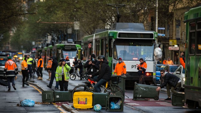 Bins that were allegedly thrown during the chaos are littered across tram lines. Picture: Getty Images