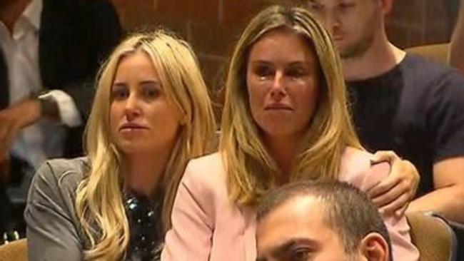 Publicist Roxy Jacenko comforts Candice Warner as David Warner speaks at his press conference.