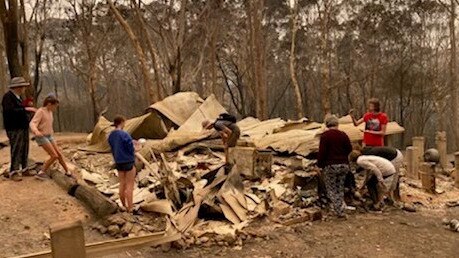 Mark Gibson and his family inspecting what remained of Banksia