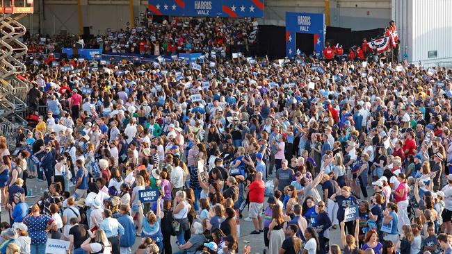 The crowd at the hangar in Detroit. You can faintly see Ms Harris, in white, speaking from the stage. Picture: Jeff Kowalsky/AFP