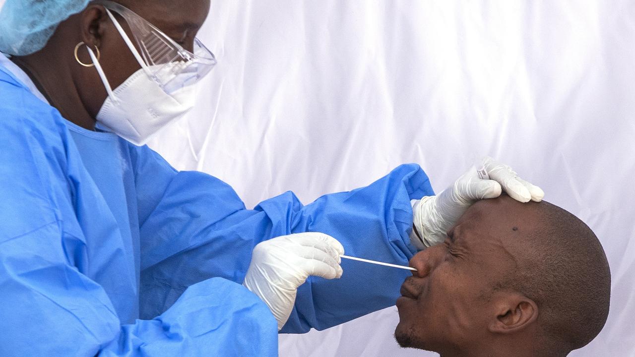 A man reacts as a heath worker to collect a sample for coronavirus testing during a screening and testing campaign in Johannesburg. Picture: Themba Hadebe/AP