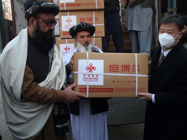 Chinese Ambassador to Afghanistan Wang Yu R and Afghan deputy Minister of refugees and repatriation affairs of the caretaker government Arsala Kharoti L attend the handover ceremony of China-donated winter supplies in Kabul. Picture: Getty