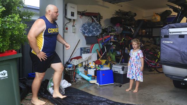 Robin Kerr and daughter Hazel from Oonoonba hurry to evacuate before the floods. Picture: Adam Head