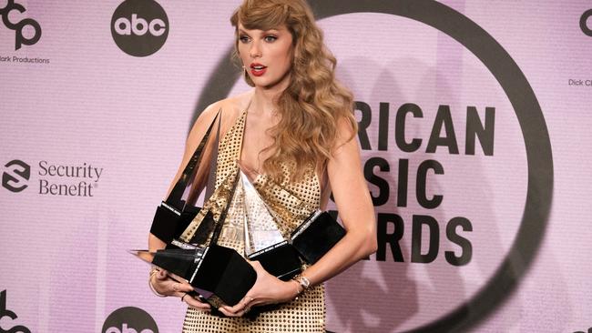 Taylor carries her AMA prizes the same way I smuggle 12 groceries through the 10 items or less lane.