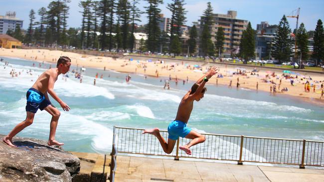 Sam Buckley and Joel Ansems-Mills from Manly jumping off the rocks into the pool at North Steyne. Picture: Phil Rogers