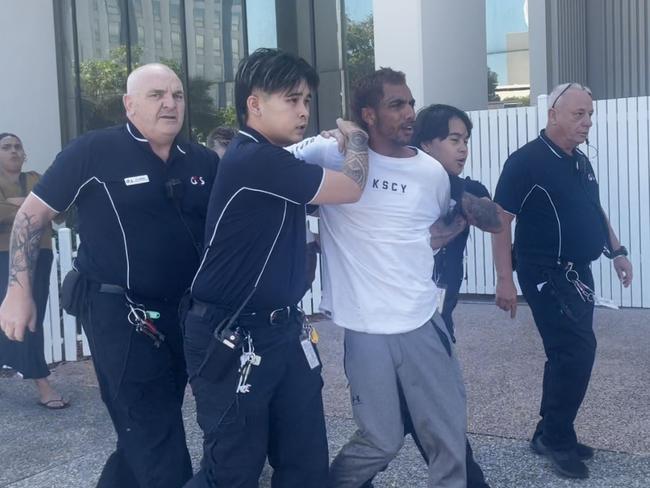 Ezra Austral was restrained by security after evading G4S court security, jumping over the barrier and running down the street at Darwin Local Court on Thursday, May 29. Picture: Zizi Averill
