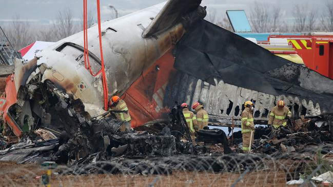 Firefighters search the wreckage of the Jeju Air plane at Muan International Airport southwest of Seoul. Picture: Chung Sung-Jun/Getty Images