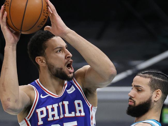 CHARLOTTE, NORTH CAROLINA - FEBRUARY 03: Ben Simmons #25 of the Philadelphia 76ers attempts a shot against Cody Martin #11 of the Charlotte Hornets during the second quarter of their game at Spectrum Center on February 03, 2021 in Charlotte, North Carolina. NOTE TO USER: User expressly acknowledges and agrees that, by downloading and or using this photograph, User is consenting to the terms and conditions of the Getty Images License Agreement.   Jared C. Tilton/Getty Images/AFP == FOR NEWSPAPERS, INTERNET, TELCOS & TELEVISION USE ONLY ==