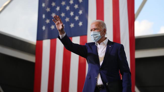 Democratic presidential nominee Joe Biden waves to supporters during a drive-in voter event in Miramar, Florida.