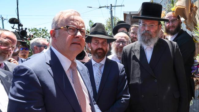 Prime Minister Anthony Albanese visits the fire damaged Adass Israel Synagogue in Ripponlea. The PM is greated by Jewish community leaders and walks to the temporary fence covered in flowers.                                                             Picture: David Caird