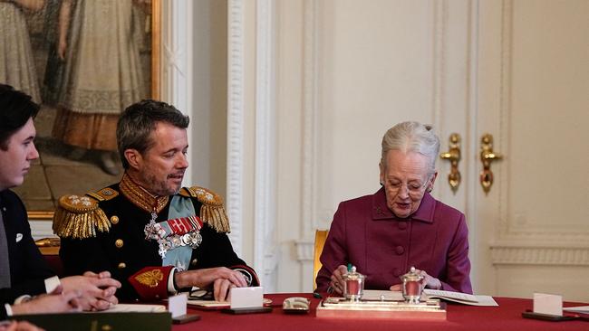 Queen Margrethe II of Denmark signs a declaration of abdication as Crown Prince Frederik of Denmark. Picture: AFP