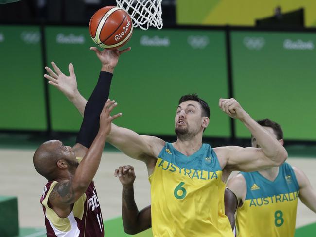 Venezuela's Jose Vargas, left, and Australia's Andrew Bogut (6) reach for a rebound during a men's basketball game at the 2016 Summer Olympics in Rio de Janeiro, Brazil, Sunday, Aug. 14, 2016. (AP Photo/Eric Gay)