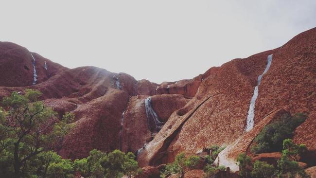 Waterfalls at Uluru as heavy rain across the Northern Territory forced the closure of the National Park. Picture: Instagram/dnjswl92