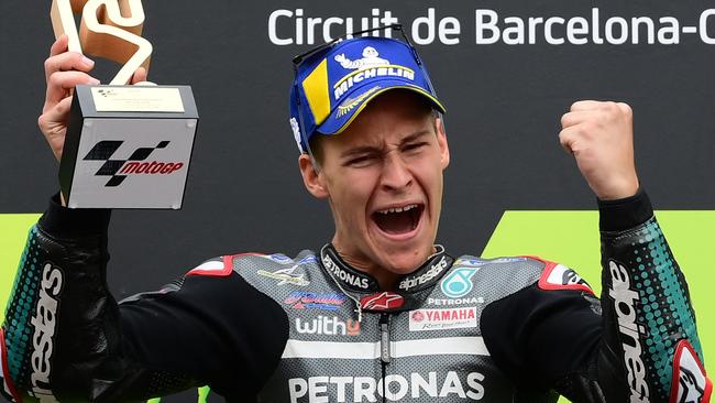 TOPSHOT - Petronas Yamaha SRT's French rider Fabio Quartararo celebrates on the podium after winning the MotoGP race of the Moto Grand Prix de Catalunya at the Circuit de Catalunya on September 27, 2020 in Montmelo on the outskirts of Barcelona. (Photo by LLUIS GENE / AFP)