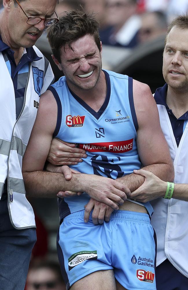 Sturt’s John Greenslade is helped off with a shoulder injury. Picture: Sarah Reed