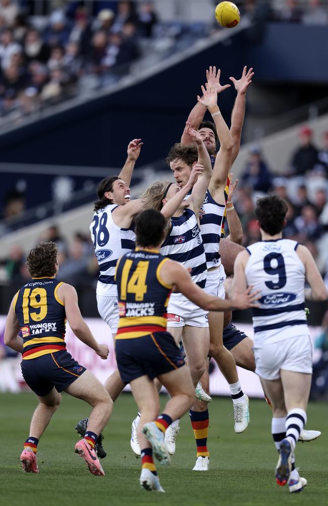 Darcy Fogarty reaches above three Geelong defenders. Picture: Martin Keep/AFL Photos