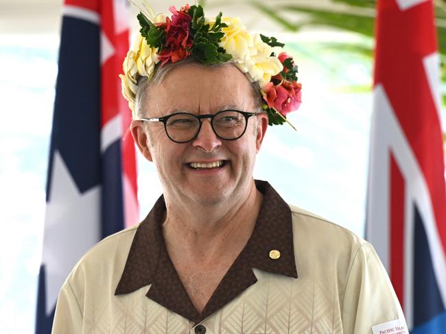 Australian Prime Minister Anthony Albanese wears a floral head piece while signing agreements with Prime Minister of Tuvalu Feleti Teo for the Australia-Tuvalu Falepili Union to come into force at the 53rd Pacific Islands Forum Leaders Meeting in Nuku'alofa, Tonga, Wednesday, August 28, 2024. Leaders from Pacific Island nations are gathering in Tonga for the 53rd Pacific Islands Forum Leaders Meeting. (AAP Image/Lukas Coch) NO ARCHIVING