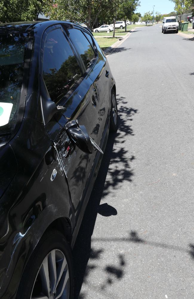 A damaged car on the street where several people were injured in a wild brawl at Redbank Plains. Picture: Annette Dew