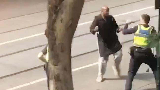 Hassan Khalif Shire Ali lunges at police before being shot on Friday.