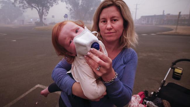 Mum Laura Langmead places a breathing mask on her daughter’s face. Picture: David Caird