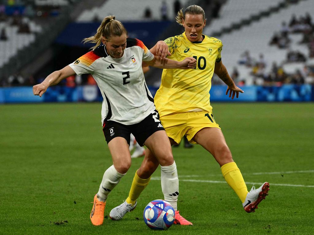 Germany's defender #02 Sarai Linder is marked by Australia's midfielder #10 Emily Van Egmond in the women's group B football match between Germany and Australia during the Paris 2024 Olympic Games at the Marseille Stadium in Marseille on July 25, 2024. (Photo by Christophe SIMON / AFP)