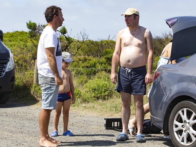 Local man Steven Bourke warns a family against swimming at The Colonnades on Christmas Day. Picture: Sarah Matray