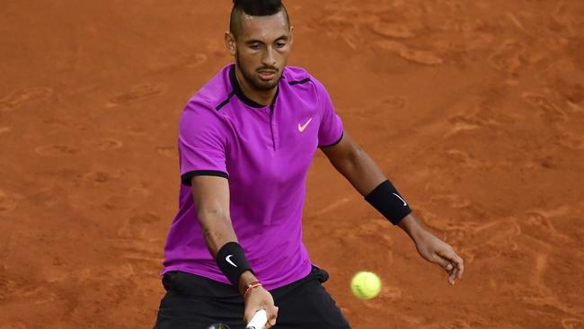 Australian tennis player Nick Kyrgios returns a ball to Spanish tennis player Rafael Nadal at the ATP Madrid Open in Madrid, on May 11, 2017. / AFP PHOTO / JAVIER SORIANO