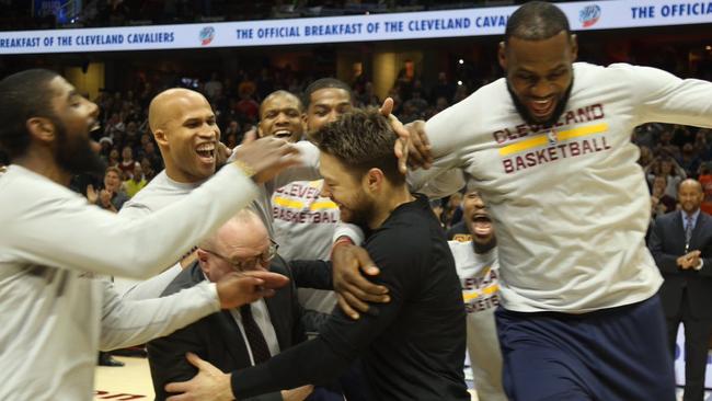 Matthew Dellavedova is mobbed by his former Cavs teammates.