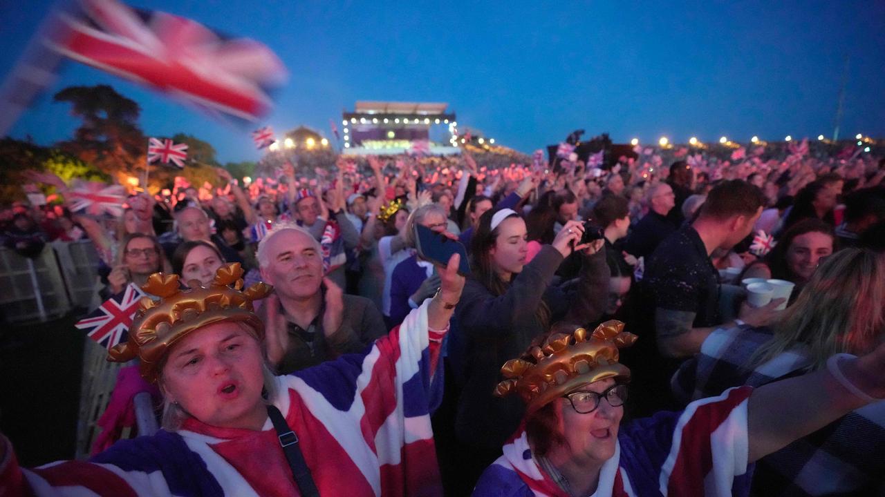 Crowds watch performers inside Windsor Castle grounds during the Coronation concert. Picture: AFP