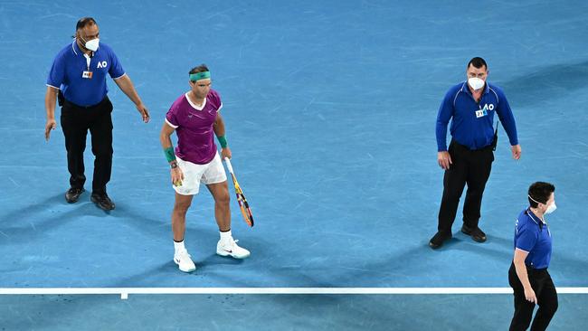 Rafael Nadal is protected by security guards. Picture: Getty Images