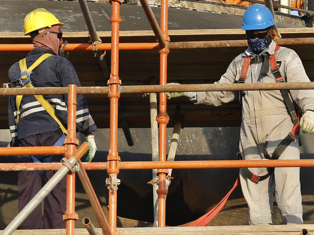 During a trip organised by Saudi information ministry, workers fix a hole in Aramco's oil separator at processing facility after the recent September 14 attack on Aramco's oil processing facility in Abqaiq, near Dammam. Picture: AP