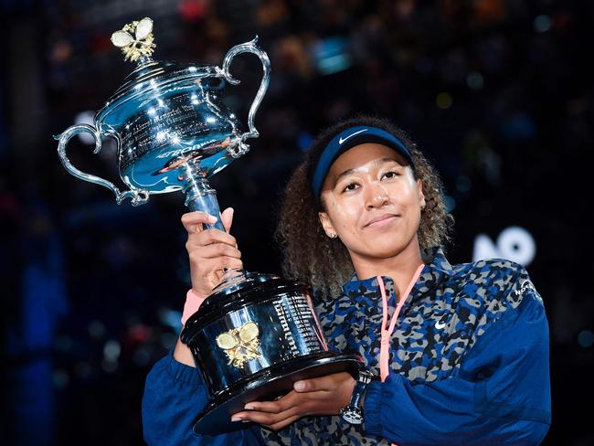 (FILES) This file photo taken on February 20, 2021 shows Japan's Naomi Osaka posing with the Daphne Akhurst Memorial Cup trophy after defeating Jennifer Brady of the US in their women's singles final match on day thirteen of the Australian Open tennis tournament in Melbourne. - Two-time Australian Open champion Naomi Osaka on January 8, 2023 pulled out of the opening Grand Slam of the year barely a week before it starts, organisers said. (Photo by William WEST / AFP) / -- IMAGE RESTRICTED TO EDITORIAL USE - STRICTLY NO COMMERCIAL USE --